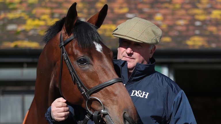 Trainer Paul Nicholls poses for a photo with Solo at his yard in Ditcheat